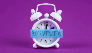 Person sitting at a desk looking overwhelmed, symbolizing that procrastination is a signal, not laziness, and showing the need for mindful management and focus.